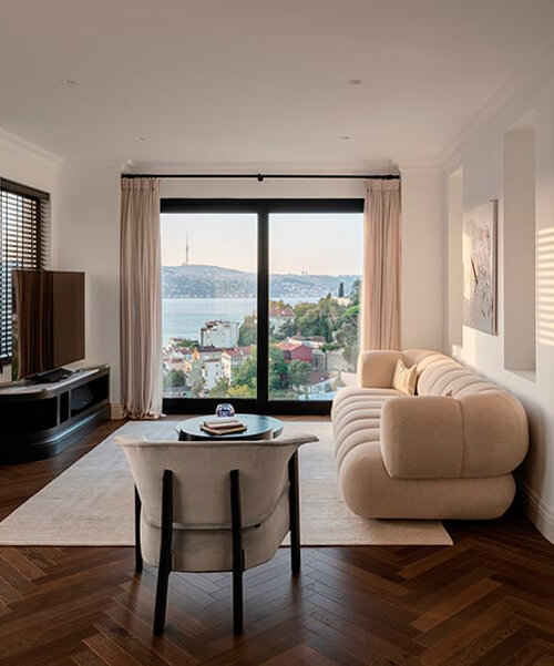 reflective sculptural staircase interposes in renovated roof apartment in istanbul