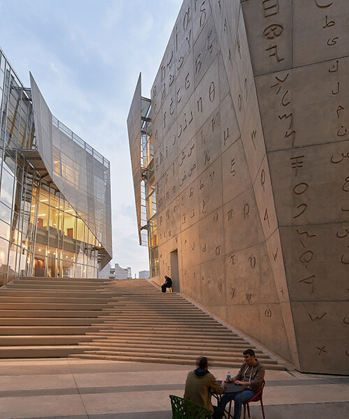 ancient alphabets are carved into the facade of jabbra library in jbeil, lebanon