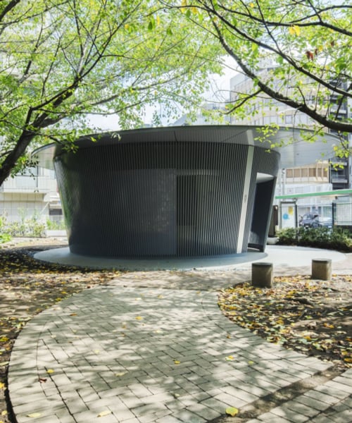 tadao ando contributes to the tokyo toilet project with a cylindrical, louvred volume